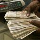 A currency dealer counts Kenya shillings at a money exchange counter in Nairobi,  file.   REUTERS/Antony Njuguna