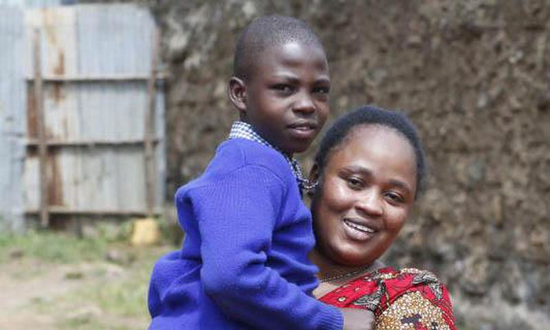 Jacqueline Khalenya embraces her son Rhonick Omondi