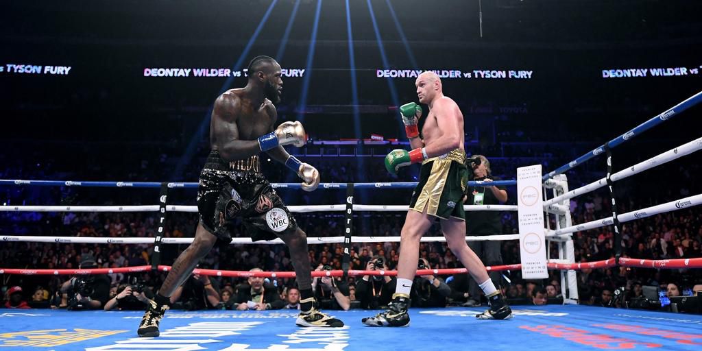 American boxer Deontay Wilder in the ring with British boxer Tyson Fury