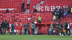 Not so fast: Players in the Sevilla v Granada match return to the pitch to play one more minute