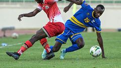 Timothy Ouma (L) of Kenya and Danny Usengimana (R) of Rwanda fight for the ball during a World Cup qualifier in Nairobi on Monday