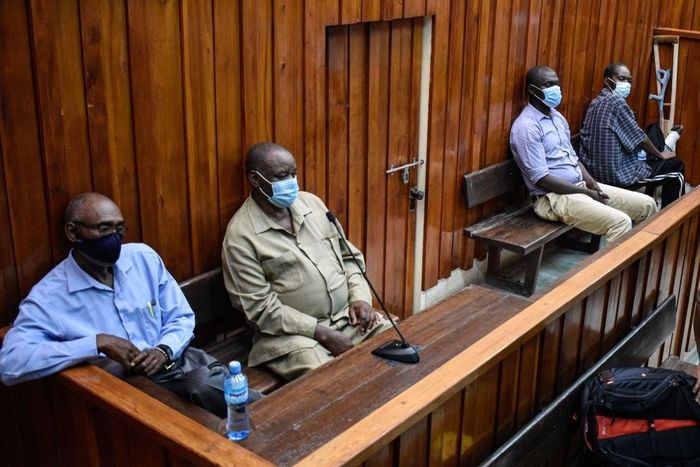Kenyan police officers, Naftali Chege (L), Charles Munyiri Wagombe (2nd-L), Ismael Baraka Bulima (2nd-R) and John Pamba (R), sit in the dock at the Mombasa Law Court in Mombasa, on November 15, 2021. (Photo by DIHOFF MUKOTO/AFP via Getty Images)