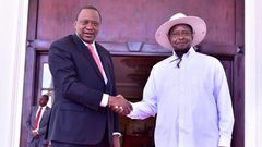 FILE PHOTO: Kenyan President Uhuru Kenyatta (L) shakes hands with Ugandan President Yoweri Museveni. (STR/AFP/Getty Images)