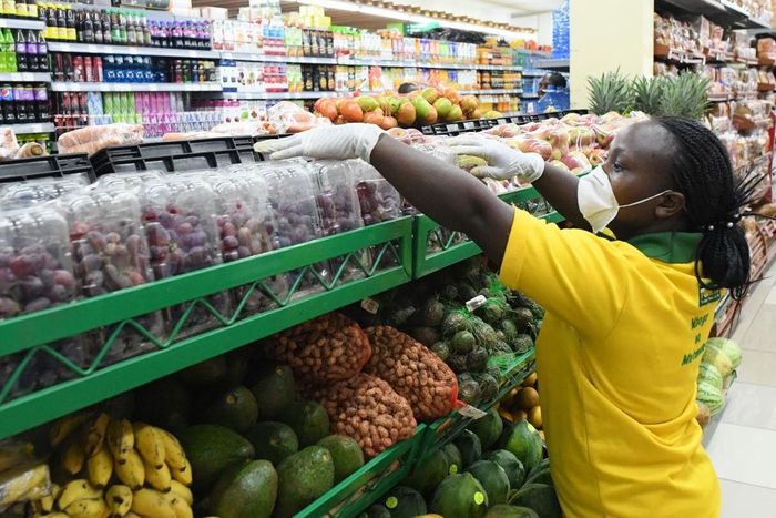 A supermarket attendant arranges fruits at a supermarket, as residents stock their homes amid concerns about the spread of the COVID-19 coronavirus, in Nairobi, Kenya, on March 30, 2020. (Photo by SIMON MAINA/AFP via Getty Images)