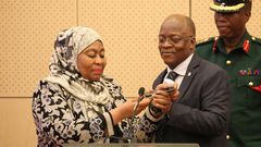 Tanzania's Vice President Samia Hassan Suluhu and President John Magufuli taking a call together in July 2019.