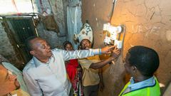 President Uhuru Kenyatta launching electricity at a Kenyan home