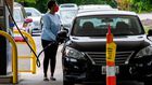 A woman fills her car at a gas station in Annapolis, Maryland, on Wednesday. Fears that the shutdown of a Colonial Pipeline fuel line because of a cyberattack would cause a gasoline shortage led to panic buying in some states.