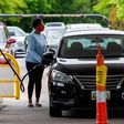 A woman fills her car at a gas station in Annapolis, Maryland, on Wednesday. Fears that the shutdown of a Colonial Pipeline fuel line because of a cyberattack would cause a gasoline shortage led to panic buying in some states.