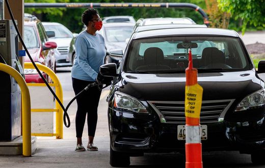 A woman fills her car at a gas station in Annapolis, Maryland, on Wednesday. Fears that the shutdown of a Colonial Pipeline fuel line because of a cyberattack would cause a gasoline shortage led to panic buying in some states.