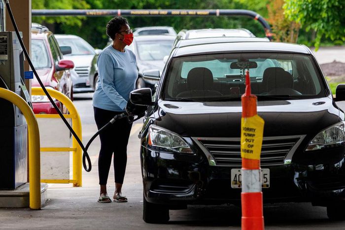 A woman fills her car at a gas station in Annapolis, Maryland, on Wednesday. Fears that the shutdown of a Colonial Pipeline fuel line because of a cyberattack would cause a gasoline shortage led to panic buying in some states.
