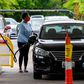 A woman fills her car at a gas station in Annapolis, Maryland, on Wednesday. Fears that the shutdown of a Colonial Pipeline fuel line because of a cyberattack would cause a gasoline shortage led to panic buying in some states.