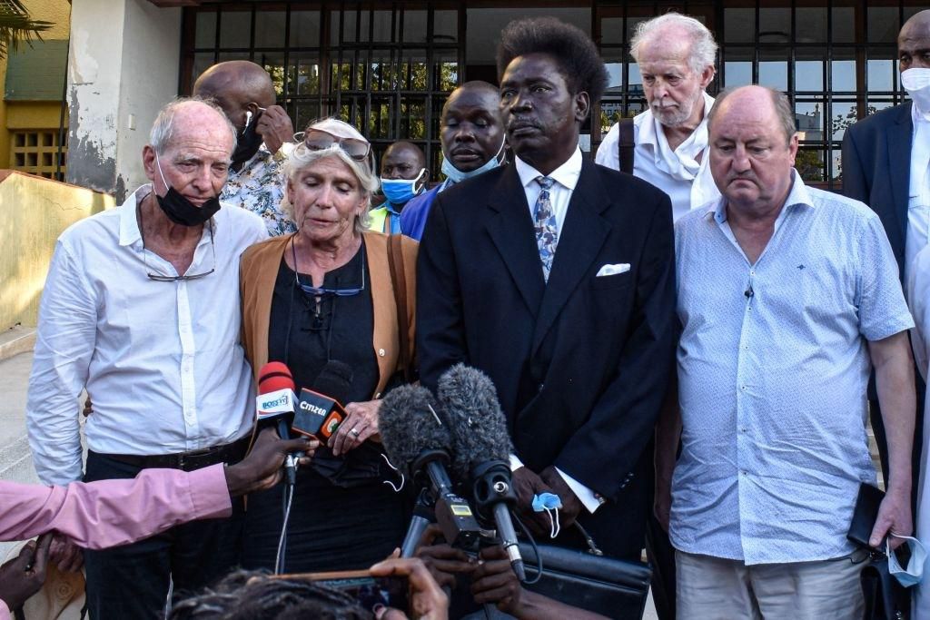 Hilary Monson (2nd L), the mother of late Alexander Monson, speaks to the media with her husband John Lockhart Mure (L) and ex-husband Lord Nicholas Monson (R) outside the Mombasa Law Court in Mombasa, on November 15, 2021. (Photo by DIHOFF MUKOTO/AFP via Getty Images)