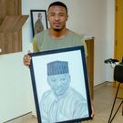 Alikiba holding his late Father's Portrait