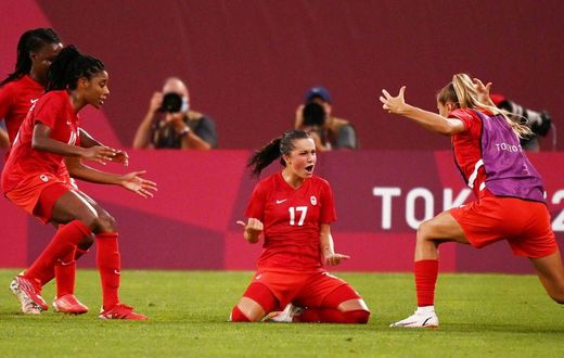 Canada's Jessie Fleming (C) celebrates after scoring the winning goal against the USA