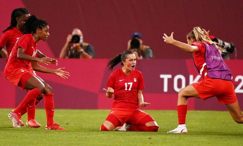 Canada's Jessie Fleming (C) celebrates after scoring the winning goal against the USA