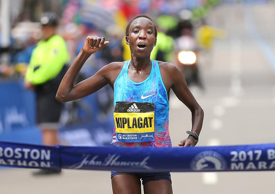 Edna Kiplagat crosses the finish line of the 121st Boston Marathon on April 17. It was her first time running the race. (John Tlumacki/Boston Globe via Getty Images