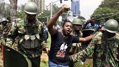 Kenyan activist Boniface Mwangi is arrested during a protest in Nairobi on February 13, 2014. The demonstration entitled "State of the Nation" was held to protest against rising cases of corruption in the government, lack of safety in public places, hi...