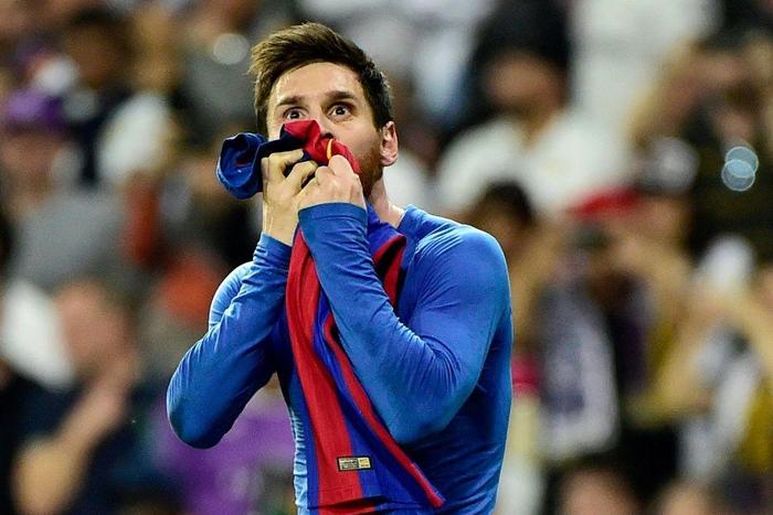 Iconic: Lionel Messi kisses his jersey after celebrating his last-minute goal against Real Madrid in 2017
