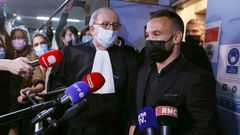 French football player Mathieu Valbuena (R), involved in a 'sex tape case', addresses media representatives next to lawyer Paul Albert Iweins (C) inside a court