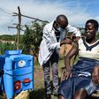 TOPSHOT - A medical health worker injects the Oxford/AstraZeneca Covid-19 vaccine to a woman as they visit door-to-door to deliver the vaccines to people who live far from health facilities in Siaya, Kenya, on May 18, 2021. (Photo by Brian ONGORO / AFP...