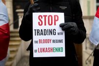 A protester holds a placard that saying "Stop trading with the bloody regime of Lukashenko" during the demonstration. Protesters gathered at the Long Market in Gdansk to express their opposition to the regime of Alexander Lukashenko in Belarus, to express solidarity with political prisoners and to express dissatisfaction with the migration situation on the Polish-Belarusian border. (Photo by Mateusz Slodkowski/SOPA Images/LightRocket via Getty Images)
