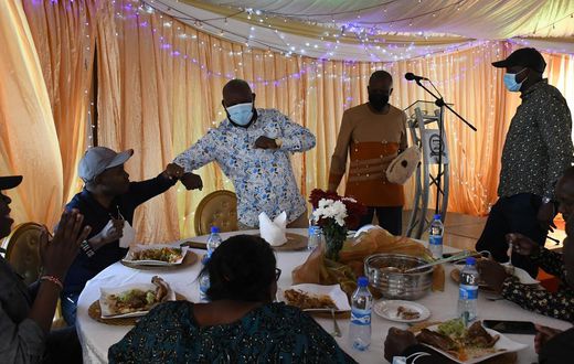 Guests eating at Kieni MP Kanini Kega's home during an event to celebrate his son's rite of passage
