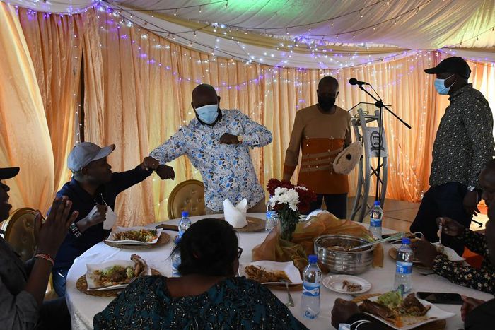 Guests eating at Kieni MP Kanini Kega's home during an event to celebrate his son's rite of passage