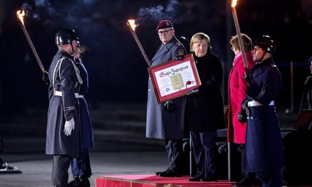 The German military’s highest civilian honour was bestowed on Angela Merkel at a ceremony at the defence ministry in Berlin. Photograph: Getty Images