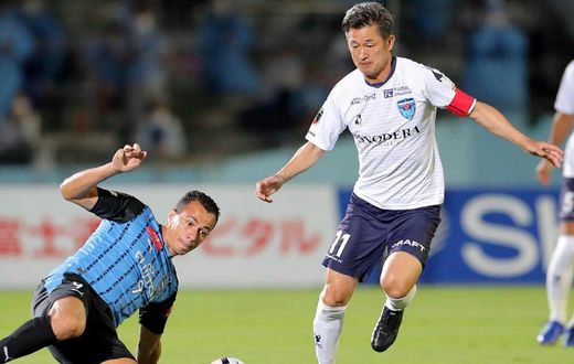 Japanese footballer Kazuyoshi Miura (right) says he wants to continue playing at the age of 54