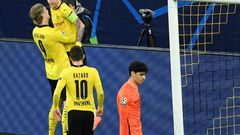 Erling Braut Haaland (L) celebrates scoring Borussia Dortmund's opening goal by lifting teammate Marco Reus off his feet