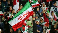 Iranian women cheer ahead of the World Cup Qatar 2022 Group C qualification football match between Iran and Cambodia at the Azadi stadium in the capital Tehran on October 10, 2019
