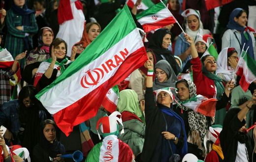 Iranian women cheer ahead of the World Cup Qatar 2022 Group C qualification football match between Iran and Cambodia at the Azadi stadium in the capital Tehran on October 10, 2019