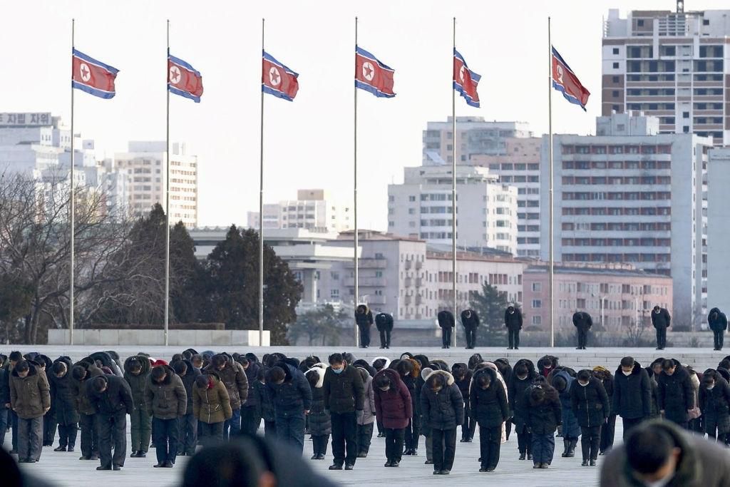 North Korean citizens hold a moment of silence in Pyongyang on Dec. 17, 2021, the 10th anniversary of the death of North Korea's second leader Kim Jong Il. (Photo by Kyodo News via Getty Images)