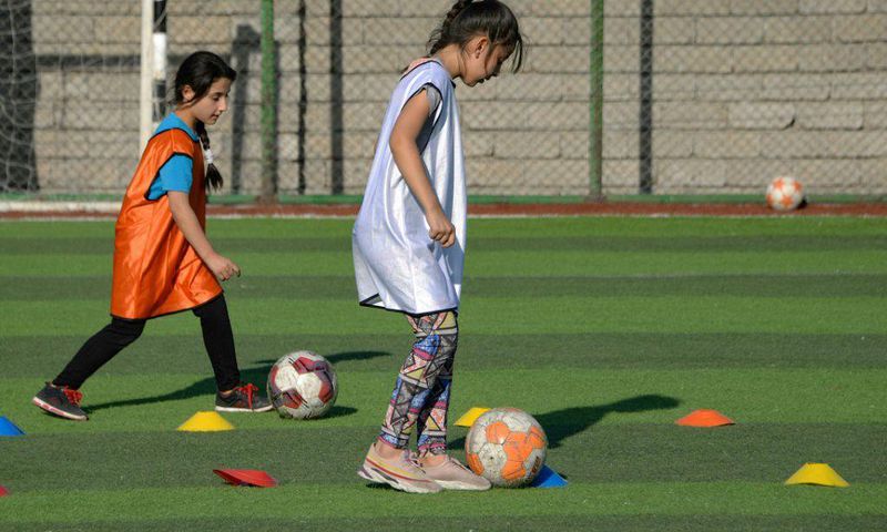 Iraqi girls take part in a football training session at the Bartalla sports club, in the former jihadist stronghold of Bartalla