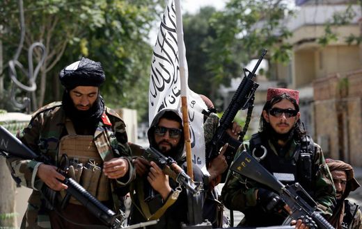 Taliban fighters display their flag on patrol in Kabul, Afghanistan, on Thursday, Aug. 19, 2021.
