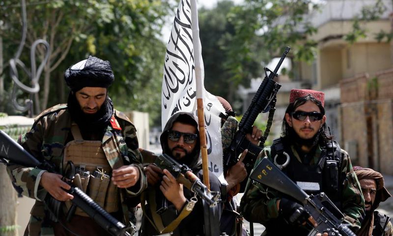 Taliban fighters display their flag on patrol in Kabul, Afghanistan, on Thursday, Aug. 19, 2021.