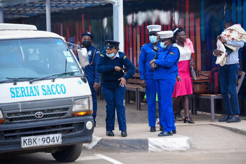 Police officers guiding matatus at Green Park terminus