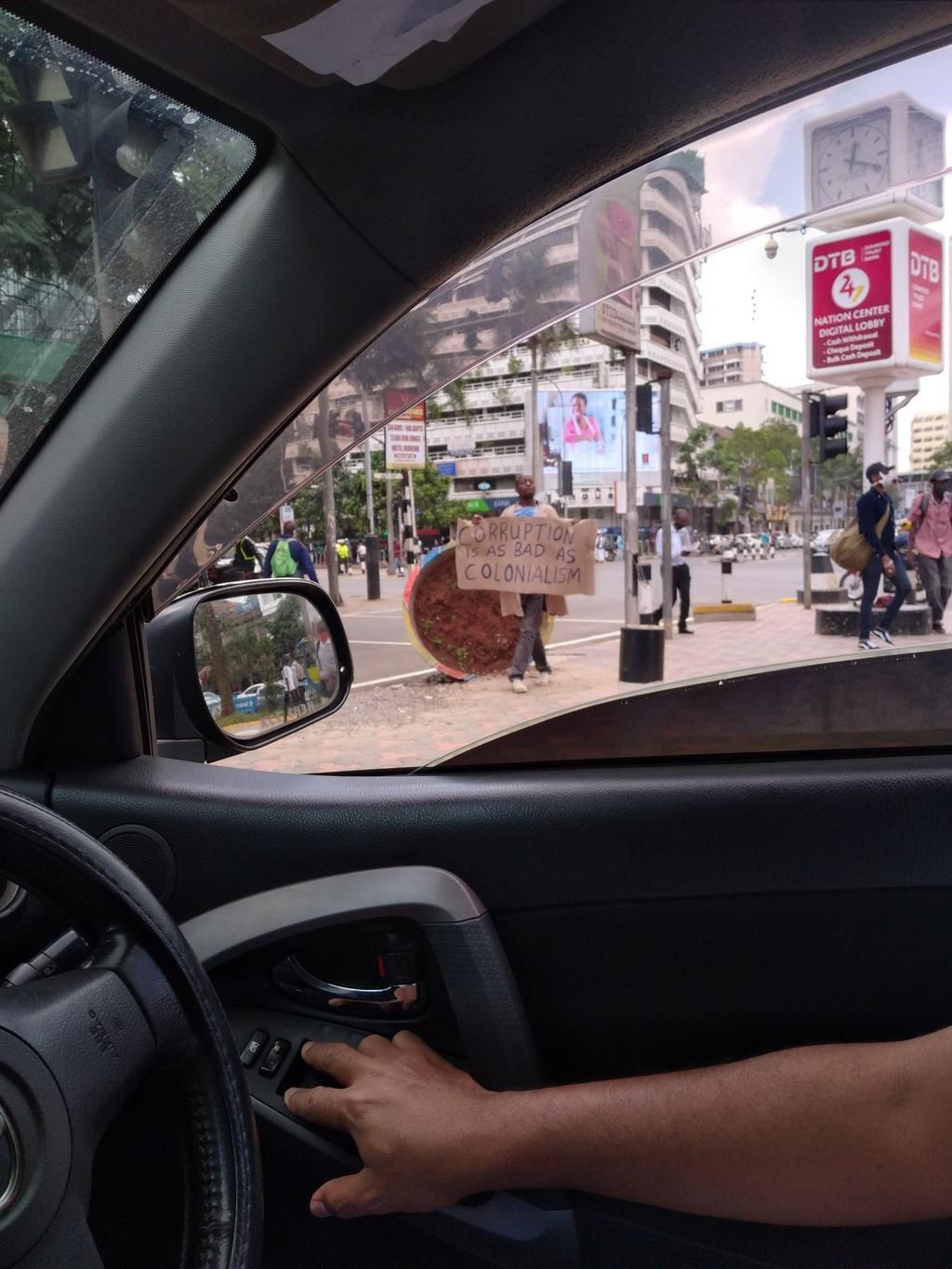 A Kenyan holding up an anti-corruption protest placard