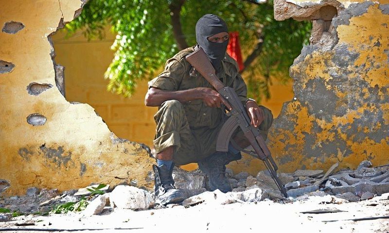 A Somali soldier stands guard next to the site where Al Shebab militants carried out a suicide attack against a military intelligence base in Mogadishu on June 21, 2015. Shebab militants launched a major suicide raid on June 21 against a military intel...