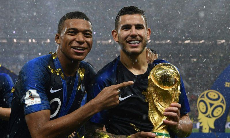 Lucas Hernandez (right) with Kylian Mbappe after winning the World Cup in 2018