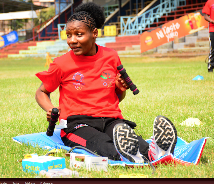 Faith Ogallo tries out the training kit donated by NOCK at the RFUEA grounds.