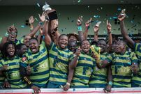 Kenya Commercial Bank's team layers celebrate as they hold the trophy after winning the Rugby Kenya Cup's final match against Kabras Sugar by 29-24 at the KCB Sports Club in Nairobi, on March 24, 2018. (YASUYOSHI CHIBA/AFP via Getty Images)