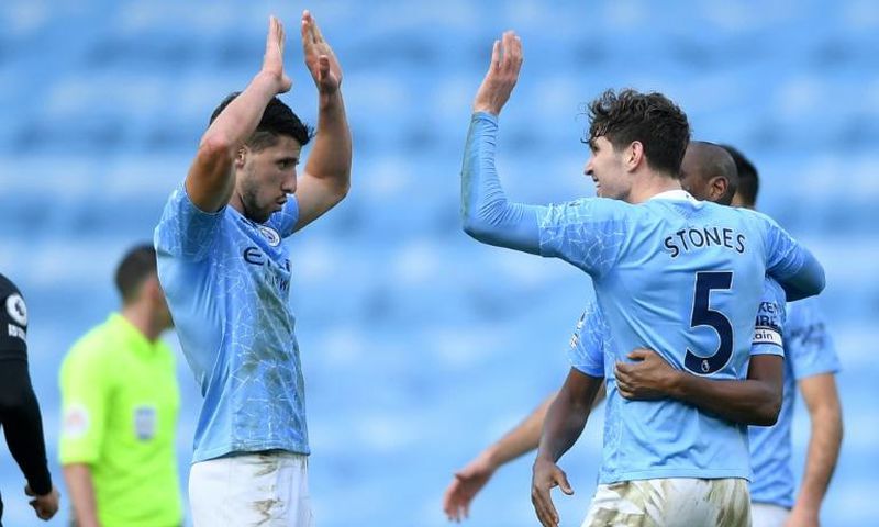 Ruben Dias (left) and John Stones struck to send Manchester City 13 points clear in the Premier League