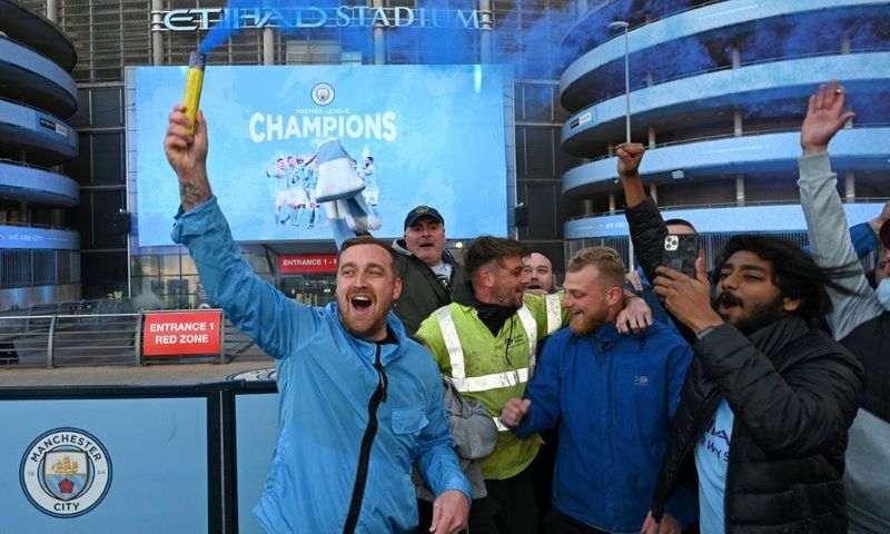 Manchester City fans celebrate winning the Premier League title