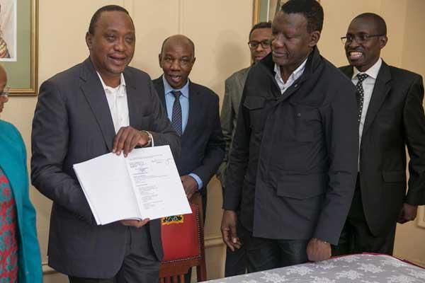 President Uhuru Kenyatta with his legal team including Evans Monari (back right)