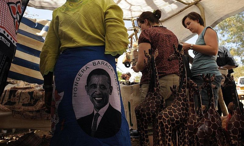 Photo made January 18, 2009 shows tourists shopping in a stall selling 'Obama' merchandise at Nyang'oma village, Kogelo, during festivities to celebrate the anticipated inauguration of America's President elect, Barack Obama. TONY KARUMBA/AFP via Getty...