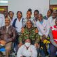 President Uhuru Kenyatta (in camouflage jacket) poses for a photo with health staff in one of the facilities