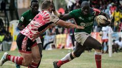 {FILE PHOTO} Alvin Otieno Ochieng (R) of Kenya's national team Shujaa blocks Ruan Mostert of Samurai RFC during the final of Safari Sevens, Kenya's annual rugby sevens tournament with professional and amature teams, in Nairobi, Kenya, on November 11, 2...