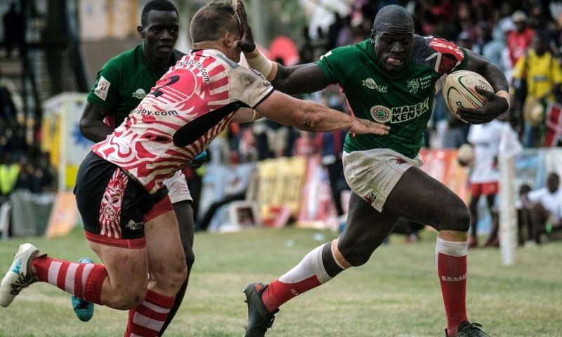 {FILE PHOTO} Alvin Otieno Ochieng (R) of Kenya's national team Shujaa blocks Ruan Mostert of Samurai RFC during the final of Safari Sevens, Kenya's annual rugby sevens tournament with professional and amature teams, in Nairobi, Kenya, on November 11, 2...