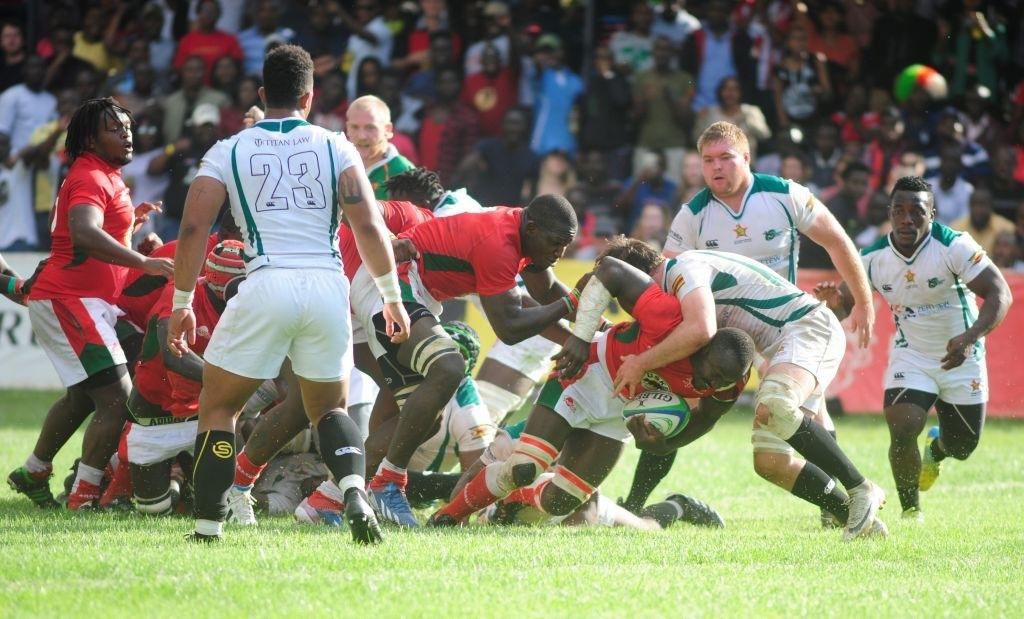 NAIROBI, KENYA - JUNE 30: In this handout image provided by the APO Group, Kenya's Dalmus Chituyi scores the winning try as Kenya Simbas beat Zimbabwe Sables 45-36 during the Rugby World Cup qualifier and Rugby Africa Gold Cup match between Kenya and Z...